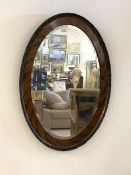 A vintage 1930s oval wall hanging mirror in moulded frame, 85cm x 62cm
