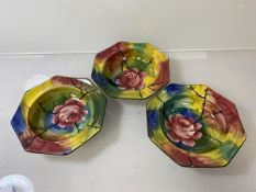 A set of three Wemyss bowls of octagonal form with stylised abstract design and cabbage rose, each