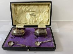 A Walker & Hall silver condiment set, Sheffield 1912, including two cauldron style pots, with