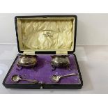 A Walker & Hall silver condiment set, Sheffield 1912, including two cauldron style pots, with
