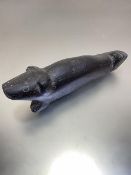 An Inuit black granite carving of a stylised seal, unsigned (h 9cm x L 30cm x w 7cm)