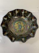 An Australian amethyst carnival glass fluted bowl with Kingfisher motif surround by gun leaves,