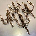 A set of four late 19thc cast brass three branch wall appliques in the Regency style with winged