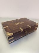 An Indian rosewood brass mounted rectangular sewing box, the hinged top enclosing a lift out tray