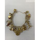 A 9ct gold charm bracelet, chain marked 375, most charms marked 9k, (10cm) combined weight 46.17