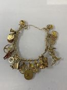 A 9ct gold charm bracelet, chain marked 375, most charms marked 9k, (10cm) combined weight 46.17