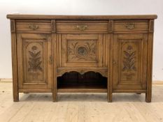 An Edwardian oak sideboard, the moulded top over three drawers, three cupboards and an open shelf,