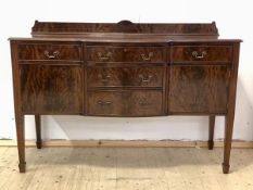 A Georgian style mahogany sideboard, ledge back over five drawers and two cupboards, raised on