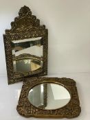 A Dutch arch hammered brass miniature wall mirror with bevelled glass, the surmount
