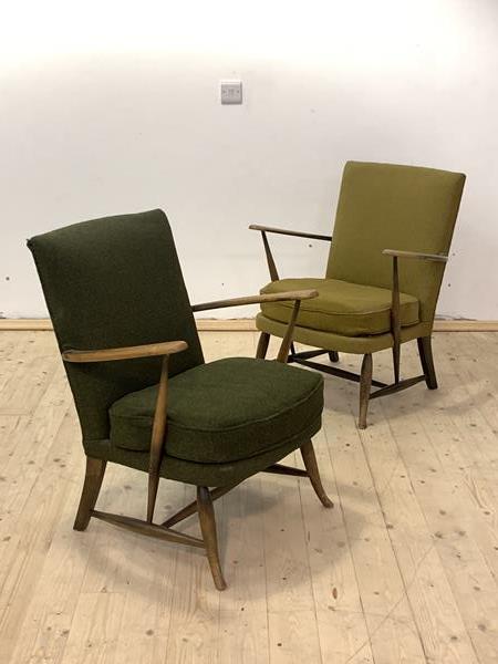 Ercol, A pair of mid century stained beech lounge chairs with upholstered backs and seats raised