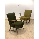 Ercol, A pair of mid century stained beech lounge chairs with upholstered backs and seats raised