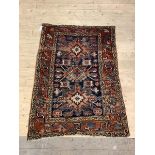 A Hand knotted Persian rug of Geometric design 141cm x 109cm