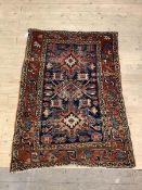 A Hand knotted Persian rug of Geometric design 141cm x 109cm