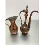 An Eastern copper rosewater ewer with faceted hinged top and panelled side with stylised flower,