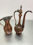 An Eastern copper rosewater ewer with faceted hinged top and panelled side with stylised flower,