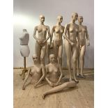 A set of six painted injection moulded polyurethane female shop display mannequins, on circular