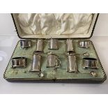 A silver condiment set, Chester 1912, including peppers, salts, pots, four spoons (one lacking)