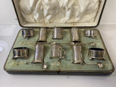 A silver condiment set, Chester 1912, including peppers, salts, pots, four spoons (one lacking)