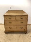 A Victorian pine chest, with ledge back over two short and two long drawers, raised on turned