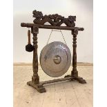 A Chinese hardwood floor standing diner gong, with dragon surmount, brass gong and beater, H96cm,