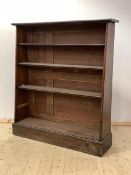 A Victorian mahogany waterfall bookcase, with three shelves, on a plinth base (Alterations)