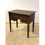 A late 18th century vernacular oak low boy, with one long and two short drawers over a fret carved