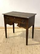 A late 18th century vernacular oak low boy, with one long and two short drawers over a fret carved