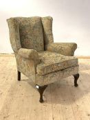 A Queen Anne style upholstered wingback chair with oak shell carved cabriole supports, H94cm, W66cm,