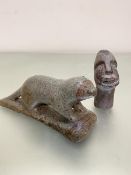 An Inuit carving of an otter of variegated green and brown soapstone, engraved verso WPO, and an