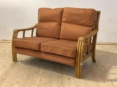 A late 20th century bamboo two seat veranda sofa with upholstered squab cushions, H89cm, W130cm,