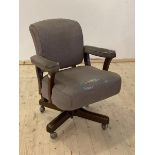 A Mid 20th century upholstered swivel and reclining desk chair on castors, H89cm, W68cm, D60cm