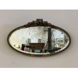 A mid 20th century Barbola wall hanging mirror, the oval bevelled glass within conforming frame,