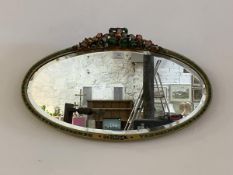 A mid 20th century Barbola wall hanging mirror, the oval bevelled glass within conforming frame,