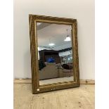 An early to mid 20th century gilt composition framed wall hanging mirror, 63cm x 87cm