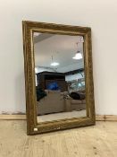 An early to mid 20th century gilt composition framed wall hanging mirror, 63cm x 87cm