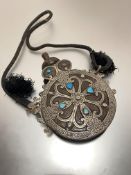 A Middle Eastern brass and white metal mounted turquoise and mother of pearl inset circular water