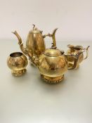 A Victorian brass engraved four piece tea and coffee service in grey floral sprays and swan finial's