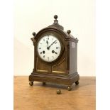 An early 20th century oak cased bracket clock, the domed case with brass ball finals and panelled