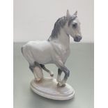 A Royal Copenhagen Danish porcelain model of a Lippizaner horse, (h 19cm x 15cm x 7cm)