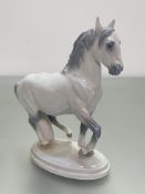 A Royal Copenhagen Danish porcelain model of a Lippizaner horse, (h 19cm x 15cm x 7cm)