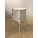 A 19th century white painted hardwood bedside cupboard, the moulded top over panelled cupboard