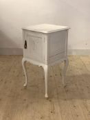 A 19th century white painted hardwood bedside cupboard, the moulded top over panelled cupboard