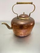 An over-sized copper brass-mounted kettle, with looped handle to top, (h 43cm x 44cm including spout