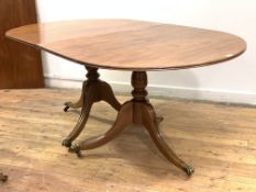 A Regency design mahogany twin pillar dining table, early 20th century, the reeded top with one leaf