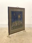 A late 20th century fire screen, with brass panel, glazed aperture with embroidered panel, raised on