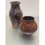 A brown terracotta pottery baluster ribbed vase with oxidised glaze, unmarked, (h 35cm x d 18cm) and