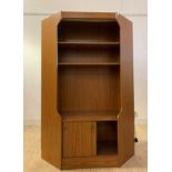 A mid century teak veneered corner unit, with illuminated interior, two shelves and sliding cupboard