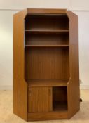 A mid century teak veneered corner unit, with illuminated interior, two shelves and sliding cupboard