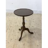 An early 20th century mahogany wine table, the circular top raised on triple splay supports,