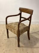 A George IV mahogany elbow chair, the crest rail and bar back with ebonised inlay, upholstered seat,